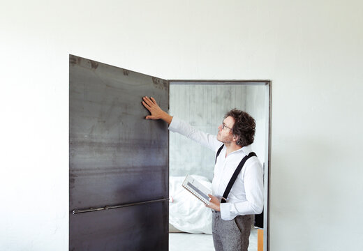 Architect checking steel door at construction site