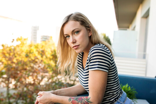 Portrait of blond young woman on balcony