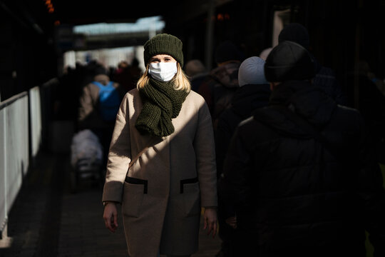 Woman with face mask standing at bus stop