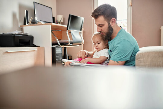 Father and daughter reading a book