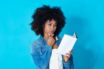 young latina woman with textbook isolated on background