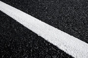 Fototapeta premium Detailed view of asphalt with freshly applied thermoplastic road marking