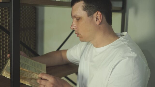Man enjoying reading a book in sunny bedroom