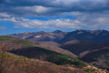 Wild forest mountain ridge with rocky viewpoint, cloudy sky and natural terrain, untouched nature landscape, hiking destination, scenic panoramic view