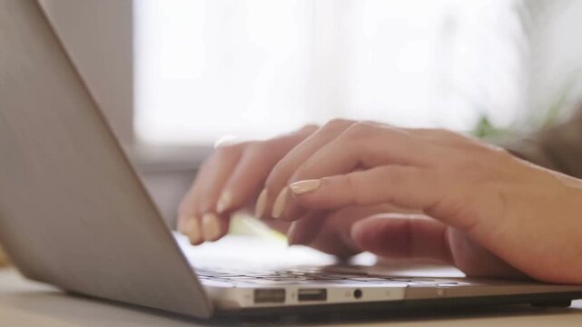 coding on laptop keyboard freelance man design web software. coder work online. Man using portable computers. Working remotely in her cozy apartment