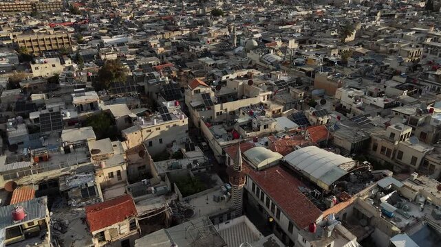 Cinematic aerial vista of the UNESCO-listed Old City of Damascus, featuring the grand Umayyad Mosque and the surrounding residential districts
