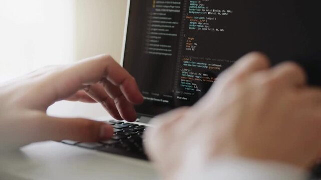Extreme close-up human hands. Side view. Cyber security close-up Coder programmer interact with chat bot, Programmer writes code in office at Night