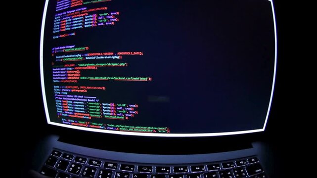 Close up of monitor screen with developing Businessman or IT programmer uses a computer while sitting at a desk at a workplace in a business office.