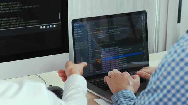 screen Coding Programmer woman writing program HTML code sitting at workplace in office, lines of digital symbols running on screen IT specialist. UHD