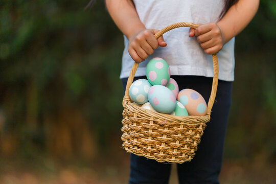 easter egg in basket with hand child holding