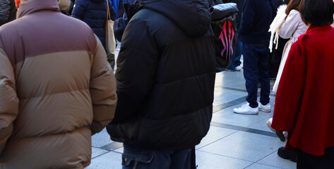 Crowd of people walking in busy city street