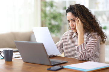 Worried adult freelance worker checking inform working at home