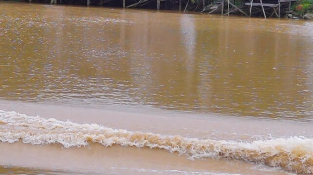 Foam trail behind the stern of a speedboat on river passР&plusmn; eddy, ship's-wake. Slow motion