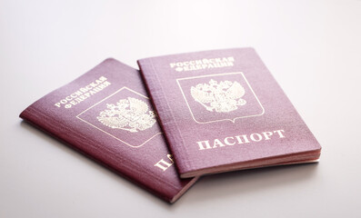 Two red passports on white background, close-up of travel documents, identity, international passport, minimal style, journey