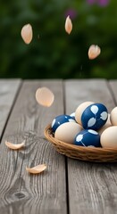 Obraz premium Blue and white eggs arranged in a small nest on a wooden table, captured mid-motion as one egg drops, adding dynamic energy to a calm composition.