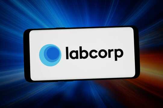 Stuttgart, Germany - 03-13-2026: In this photo illustration, the logo of US healthcare company Labcorp Holdings Inc. is displayed on a smartphone in front of abstract background on computer screen.