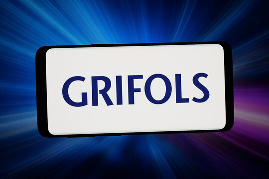 Stuttgart, Germany - 03-13-2026: In this photo illustration, the logo of Spanish healthcare company Grifols S.A. is displayed on a smartphone in front of abstract background on computer screen.