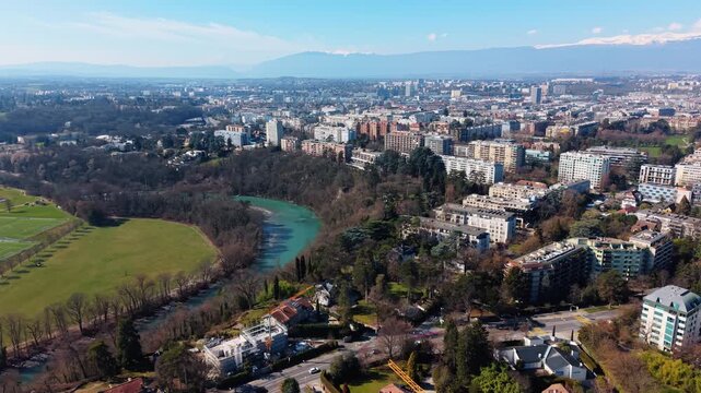 Aerial: Geneva cityscape from Conches with Arve river during the day in Canton of Geneva, Switzerland, establishing drone shot