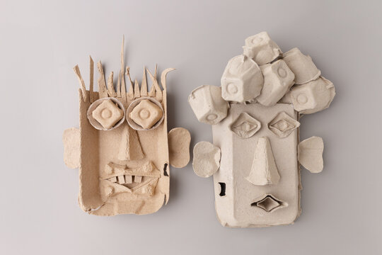 Funny faces made from recycled egg cartons for kids diy craft project. Creative paper pulp masks for school art lesson, sustainable hobby, home activity, eco friendly toy design