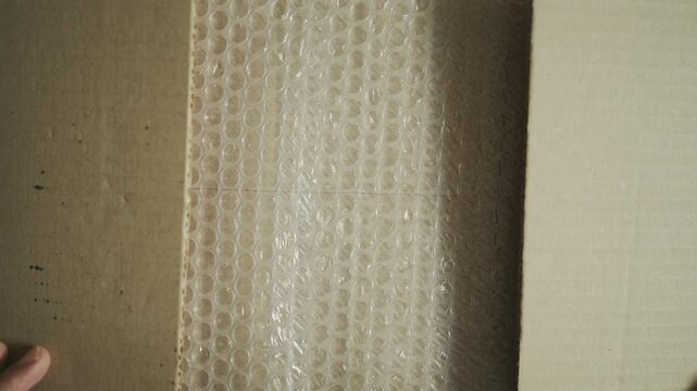 Top-Down Video of Packaging Materials with Recycled Cardboard and Bubble Wrap