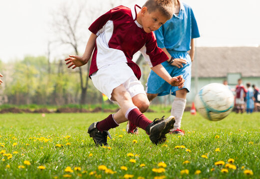 Kids soccer football - children players match on soccer field