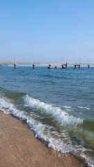 Fototapeta premium Rugen beach with wooden Seebrücke pier and gentle waves along sandy shore