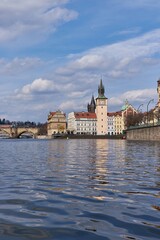 Fototapeta premium Vltava River flowing beside historic Old Town with Charles Bridge in Prague