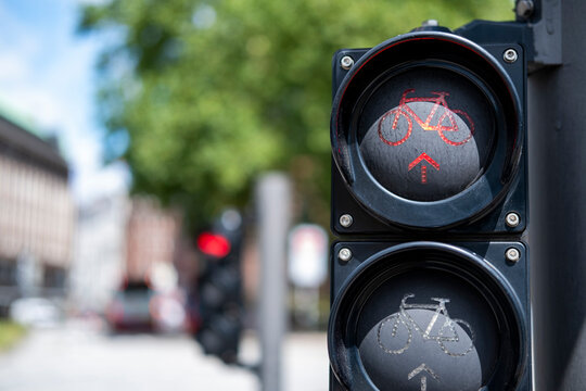 Urban mobility detail of a bicycle traffic signal light with red display on street in Hamburg Germany emphasizing cycling control and safety