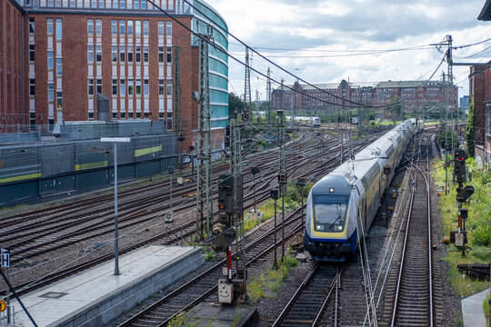 Urban mobility view of a commuter train on railway tracks near a station in Hamburg Germany with transport network lines and travel mood