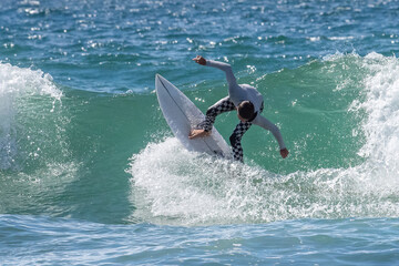 A dynamic action shot of a surfer skillfully riding an ocean wave,