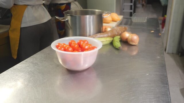 African chef preparing fresh ingredients for traditional cuisine in a professional kitchen