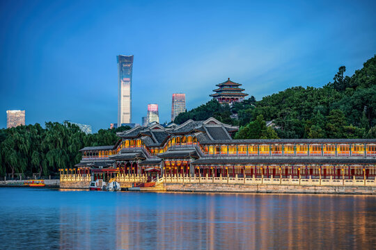 Scenic view of Beihai Park Wanchun Pavilion with modern CBD skyline, including China Zun tower at blue hour.