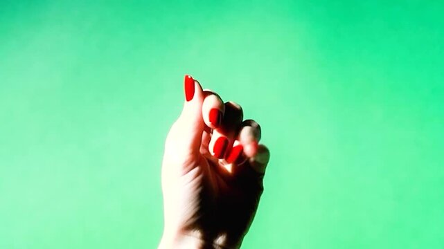 Woman's hand with red nail polish opening from a fist to a flat palm 4k Video. generated with AI