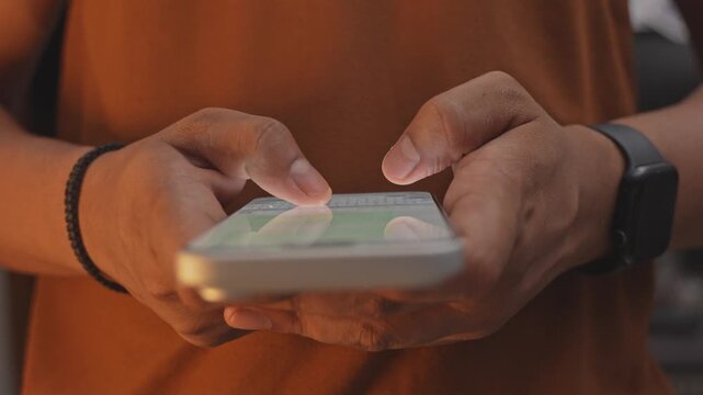 Man hands chatting and typing on smartphone macro closeup. Unrecognizable human typing text message tapping touchscreen keyboard using whatsapp application a social media