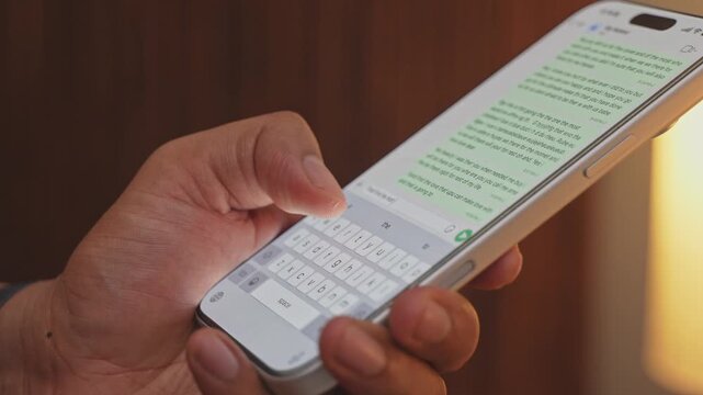 Man hands chatting and typing on smartphone macro closeup. Unrecognizable human typing text message tapping touchscreen keyboard using whatsapp application a social media