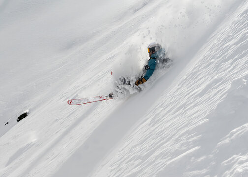 Off piste skier descending steep powder slope in Gressoney Italy
