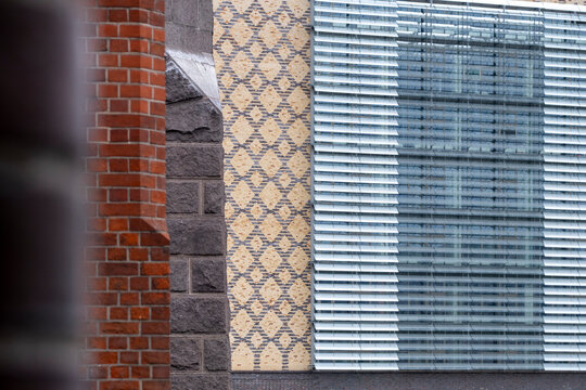 Layered urban facade collage mixing brick and glass with abstract pattern and rich texture creating distinctive architecture background material