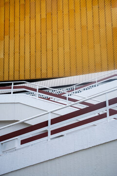 Graphic stairway detail with railing and yellow pattern in urban architecture showing minimal abstract geometry as bold background for design