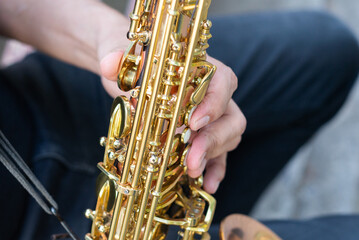Naklejka premium Authentic Musician Playing Golden Saxophone Instrument Outdoors on a Rustic Bench
