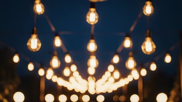 Video of warm party string lights sparkling in dark environment, seasonal celebration concept, ambient decorative lighting background, modern lifestyle visual, suspended bulb garlands forming gentle