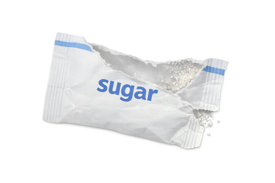 Torn sugar packet spilling white crystals