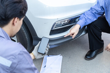 Obraz premium Auto repair shop, small business owner, garage, technology mechanic photographing wheel damage for inspection, customer consultation, quotation online service estimate, insurance claim agent support.