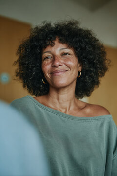 Portrait of a smiling woman with natural freckles and warm expression for healthcare consultation and wellness banner design