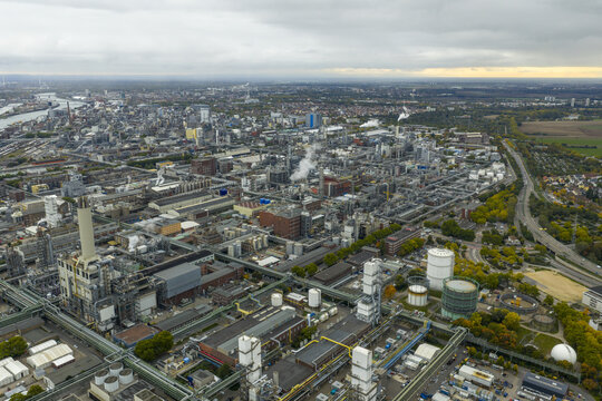 Aerial view of vast chemical plant spanning urban landscape near the rhine river, representing industrial scale and production, Ludwigshafen, Germany.