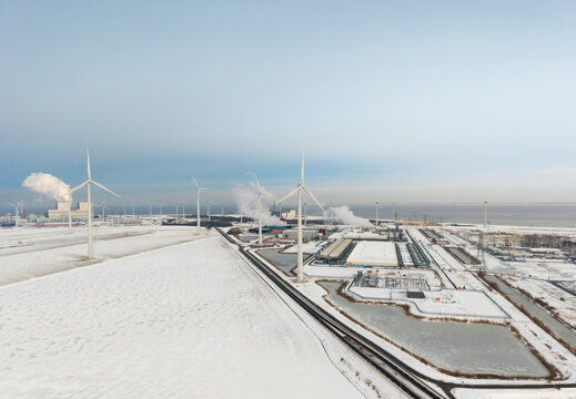 Wind turbines at snowy data center in Eemshaven the Netherlands winter