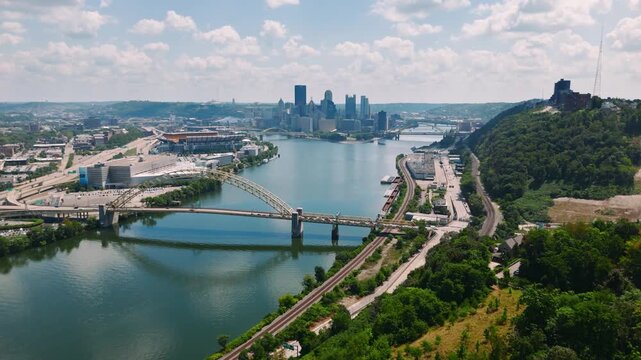 Afternoon aerial of Pittsburgh downtown with rivers, bridges, and cityscape. Great for stock and cinematic media.