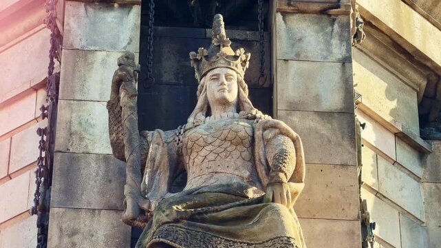 Stone statue of Queen Isabella I of Castile, base of Columbus Monument in Barcelona, Spain. Tilt up