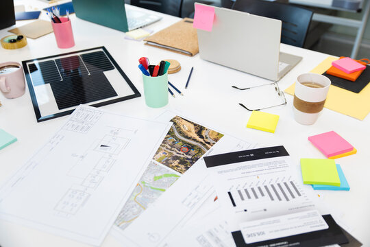 Business documents and solar panel on meeting table in office workspace