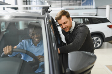 Naklejka premium A consultant at a car dealership helps a customer choose a new car
