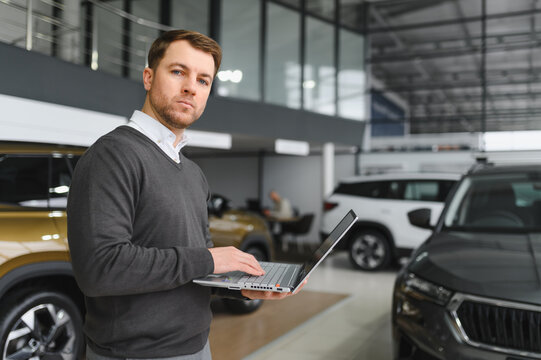 car dealer principal standing in showroom